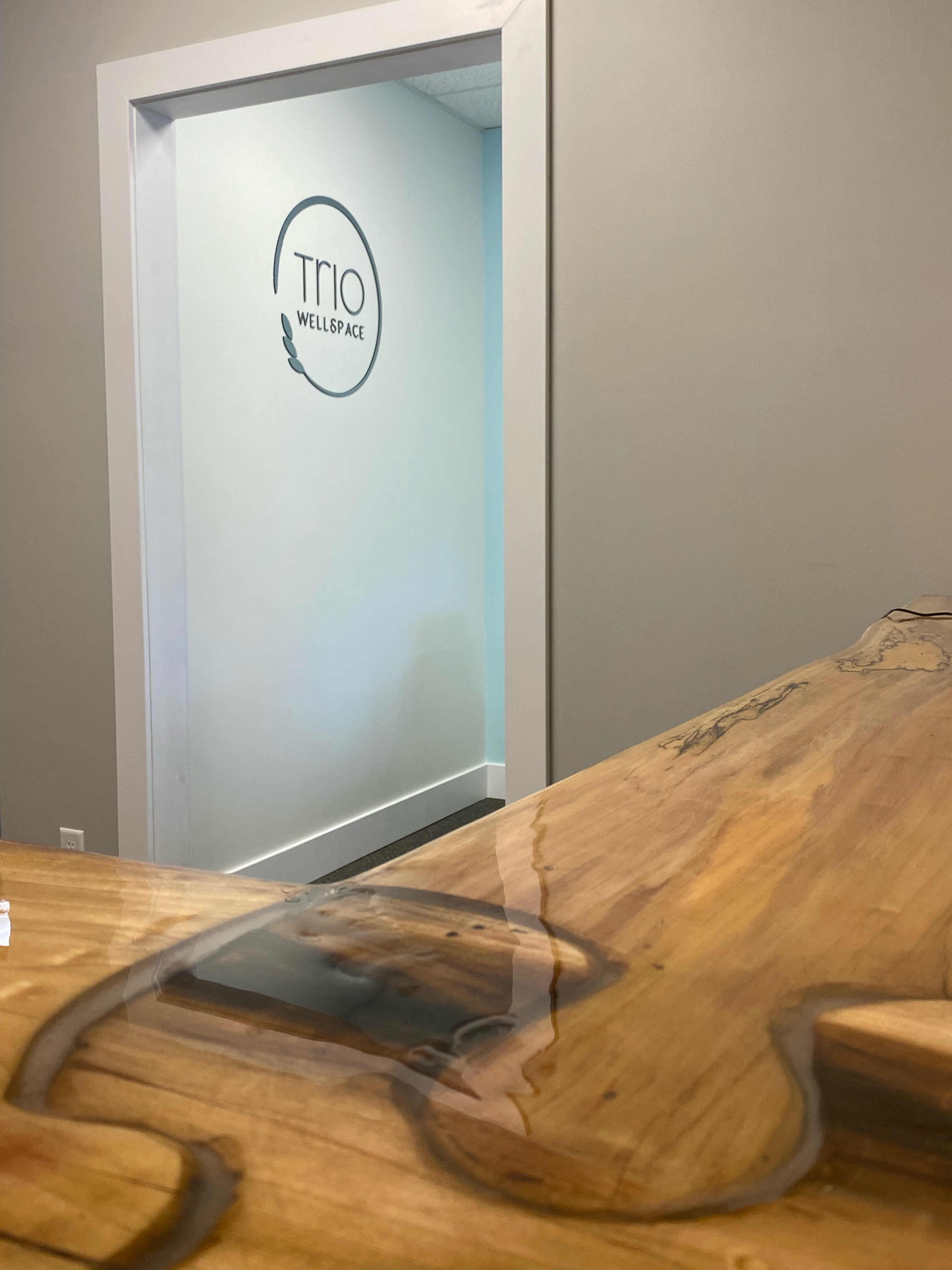 Trio Wellspace reception area with wooden table
